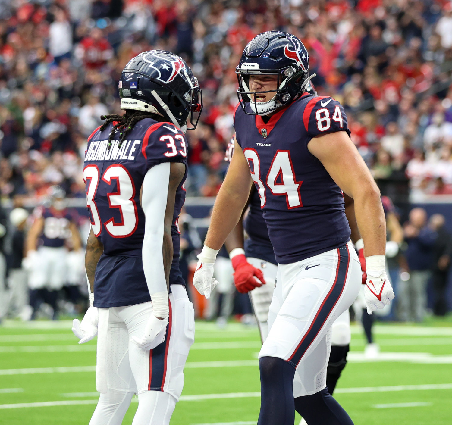 Houston Texans running back Dare Ogunbowale (33) celebrates with tight end Teagan Quitoriano (84) after a touchdown during an NFL game between the Texans and the Chiefs on Dec. 18, 2022, in Houston. The Chiefs won, 30-24, in overtime.