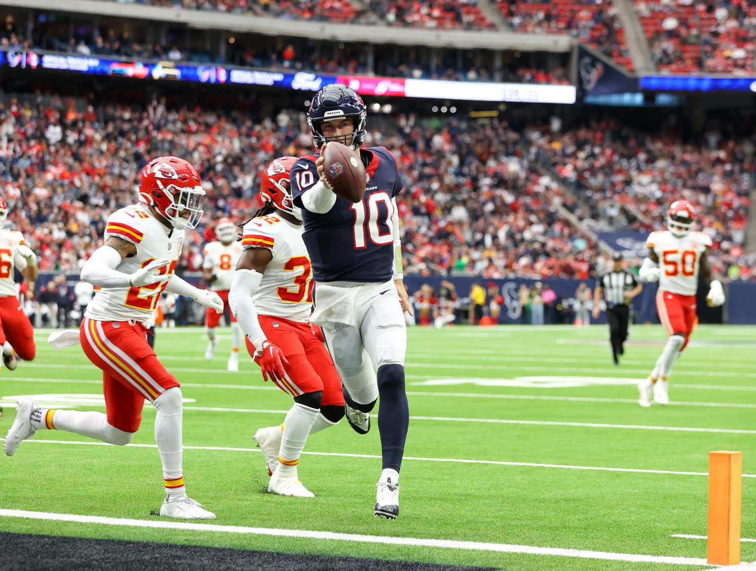Houston Texans quarterback Davis Mills (10) scores on a a 17-yard touchdown carry during an NFL game between the Texans and the Chiefs on Dec. 18, 2022, in Houston. The Chiefs won, 30-24, in overtime.