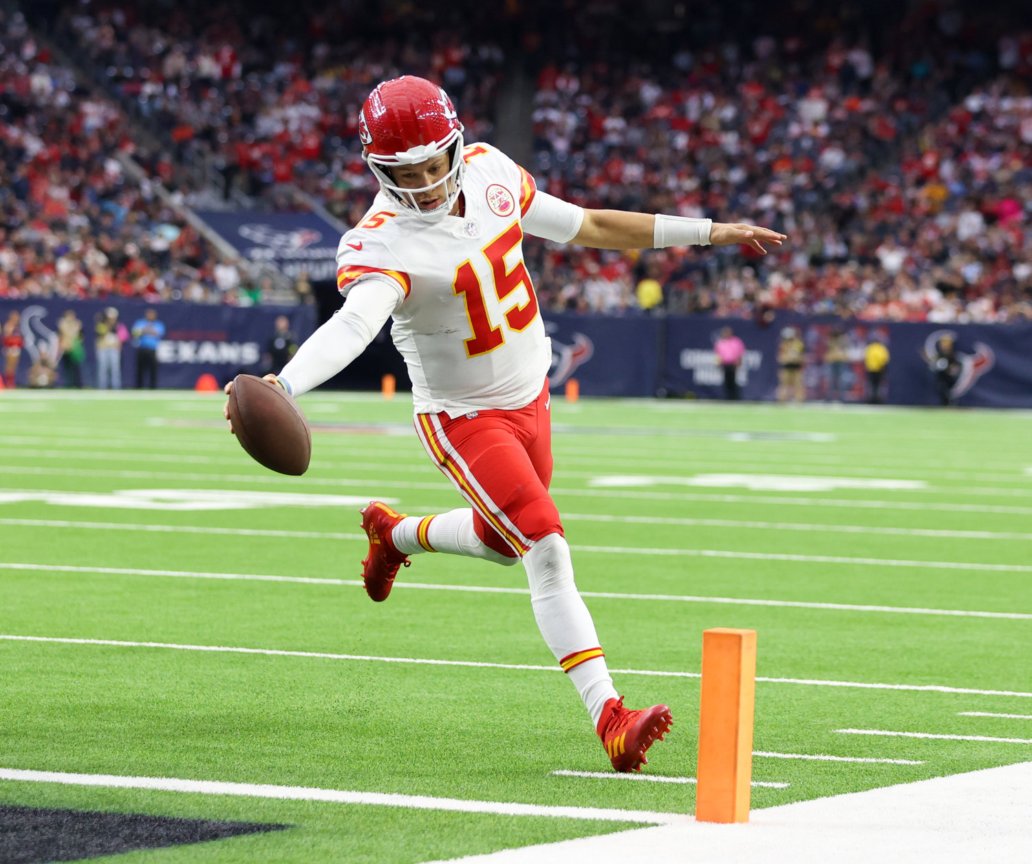 Kansas City Chiefs quarterback Patrick Mahomes (15) extends the ball across the goal line on a 5-yard touchdown carry during an NFL game between the Texans and the Chiefs on Dec. 18, 2022, in Houston. The Chiefs won, 30-24, in overtime.
