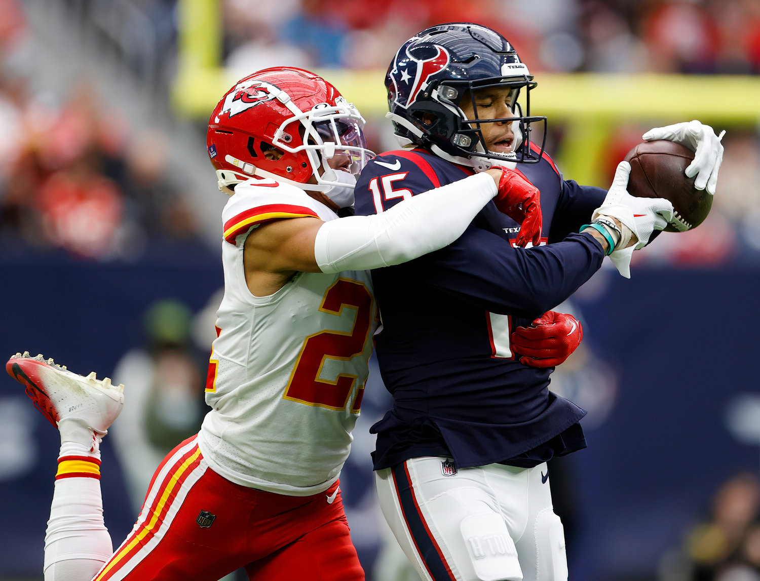 Houston Texans wide receiver Chris Moore (15) brings in a 34-yard pass over Kansas City Chiefs cornerback Trent McDuffie (21) during an NFL game between the Texans and the Chiefs on Dec. 18, 2022, in Houston. The Chiefs won, 30-24, in overtime.