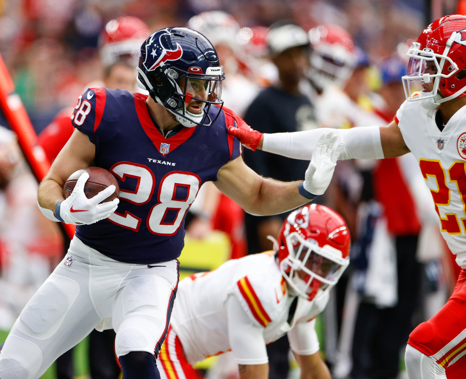 Houston Texans running back Rex Burkhead (28) fends off Kansas City Chiefs cornerback Trent McDuffie (21) on a carry during an NFL game between the Texans and the Chiefs on Dec. 18, 2022, in Houston. The Chiefs won, 30-24, in overtime.