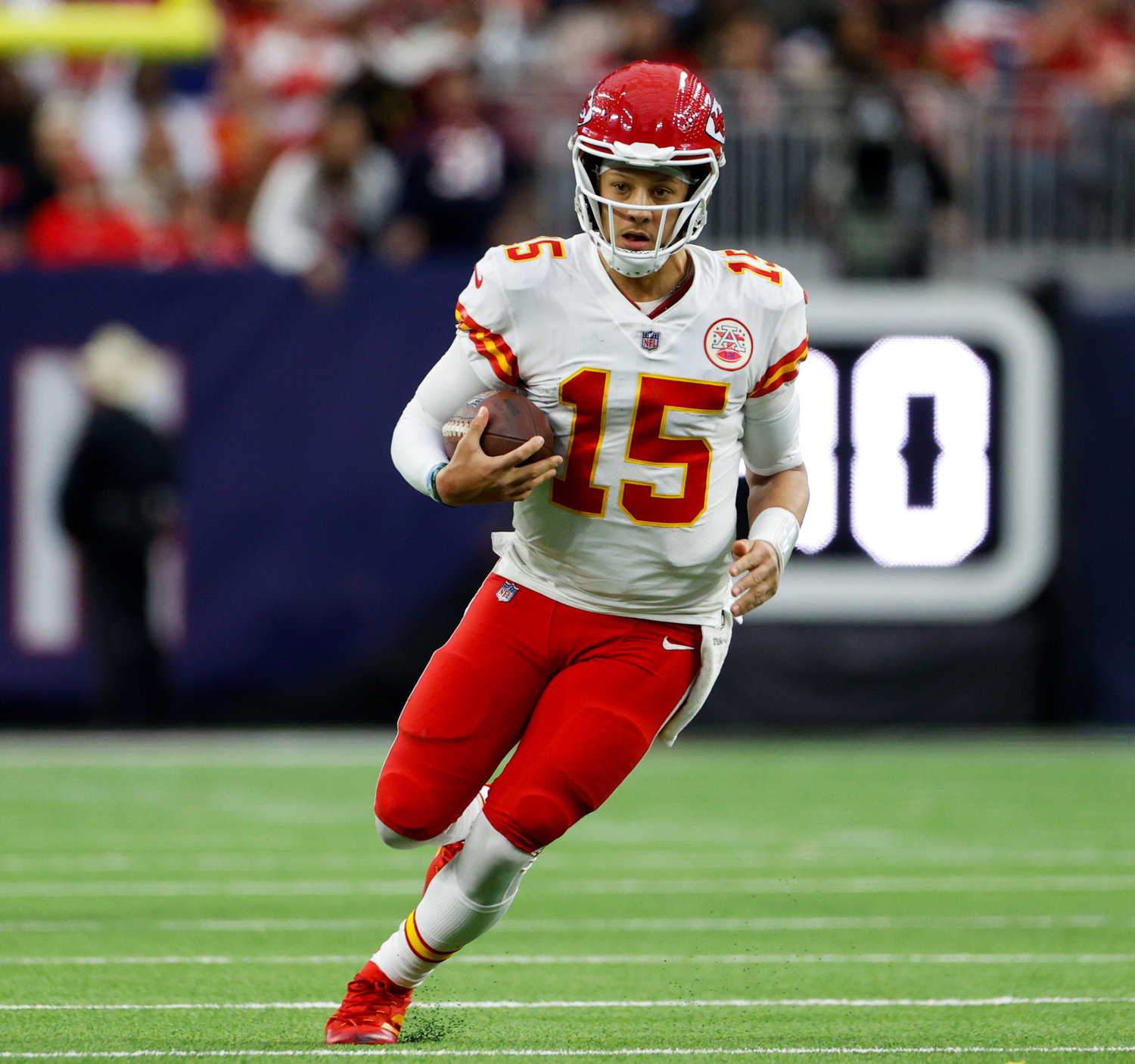 Kansas City Chiefs quarterback Patrick Mahomes (15) carries the ball to set up a potential game-winning field goal near the end of regulation in an NFL game between the Texans and the Chiefs on Dec. 18, 2022, in Houston. The kick failed but the Chiefs won, 30-24, in overtime.