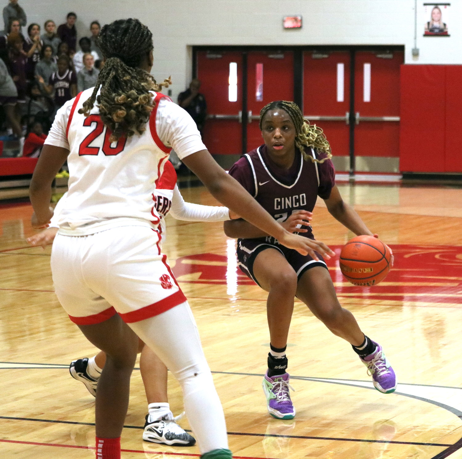 Aniya Foy dribbles around a defender during Tuesday’s game between Katy and Cinco Ranch at the Katy gym.