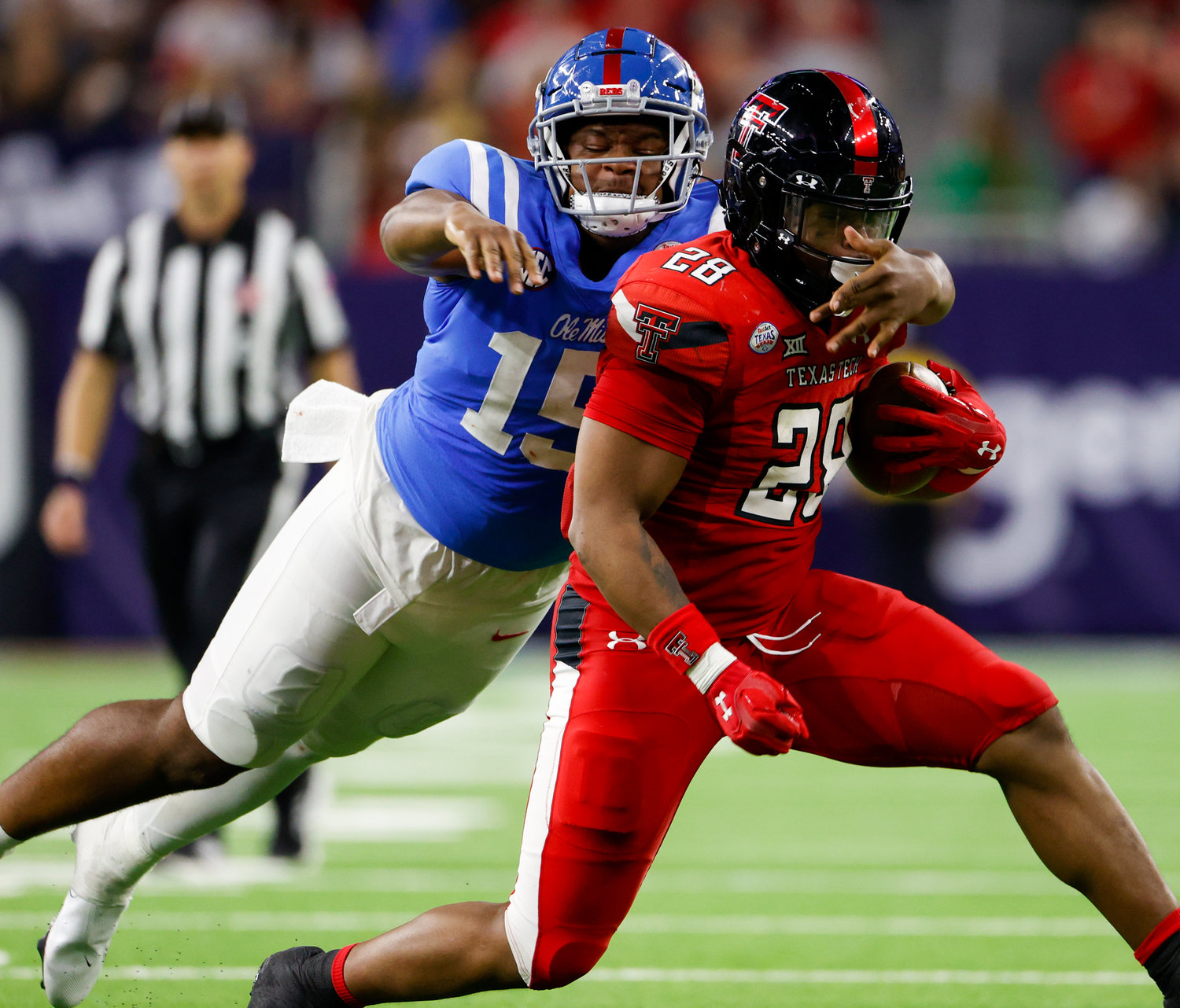 Mississippi defensive end Jared Ivey (15) works to bring down Texas Tech running back Tahj Brooks (28) on a carry during the TaxAct Texas Bowl on Dec. 28, 2022 in Houston.