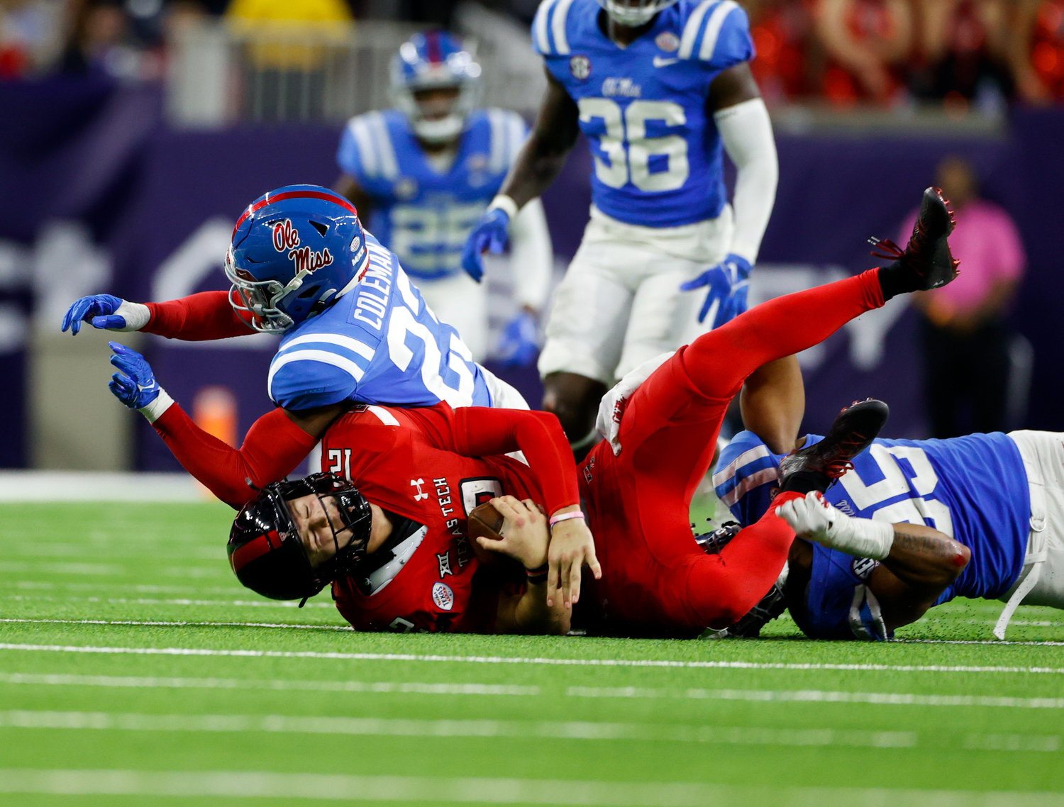 Mississippi defensive end Tavius Robinson (95) and linebacker Khari Coleman (23) tackle Texas Tech quarterback Tyler Shough (12) for a loss during the TaxAct Texas Bowl on Dec. 28, 2022 in Houston.