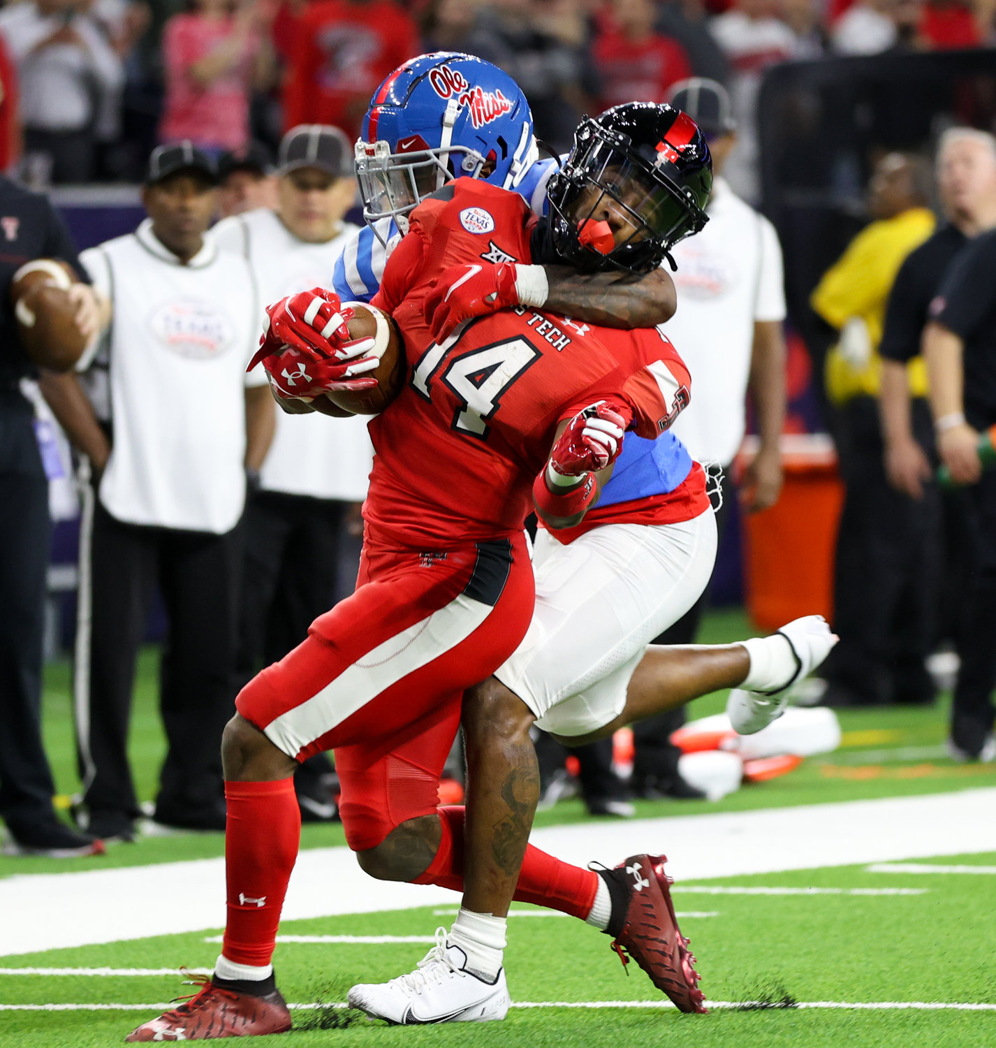 Texas Tech wide receiver Xavier White (14) is tackled on a carry during the TaxAct Texas Bowl on Dec. 28, 2022 in Houston.
