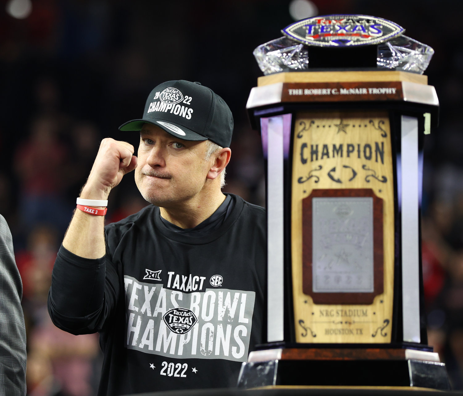 Texas Tech head coach Joey McGuire gestures while standing next to the TaxAct Texas Bowl trophy after a 42-25 win over Ole Miss on Dec. 28, 2022 in Houston.