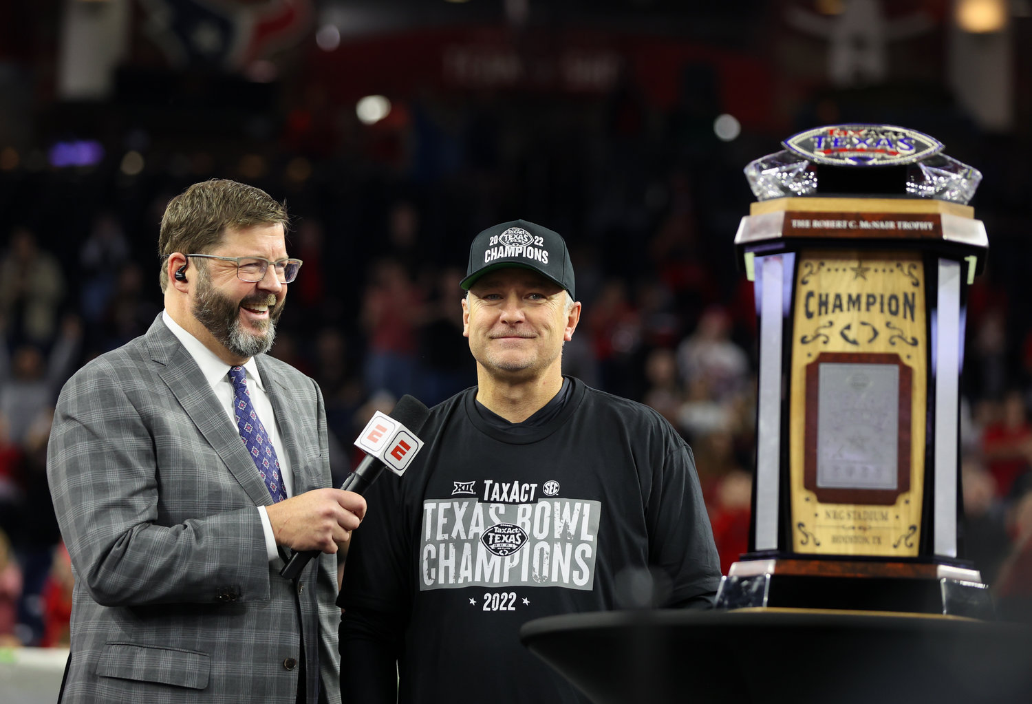 Texas Tech head coach Joey McGuire stands next to the TaxAct Texas Bowl trophy after a 42-25 win over Ole Miss on Dec. 28, 2022 in Houston.