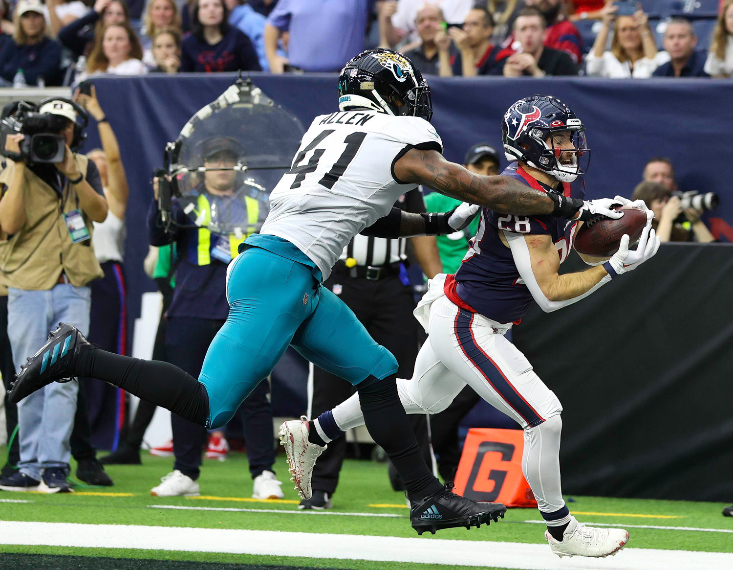 Jaguars linebacker Josh Allen (41) dislodges a would-be touchdown pass intended for Texans running back Rex Burkhead (28) during an NFL game between the Houston Texans and the Jacksonville Jaguars on Jan. 1, 2023 in Houston. The Jaguars won, 31-3.