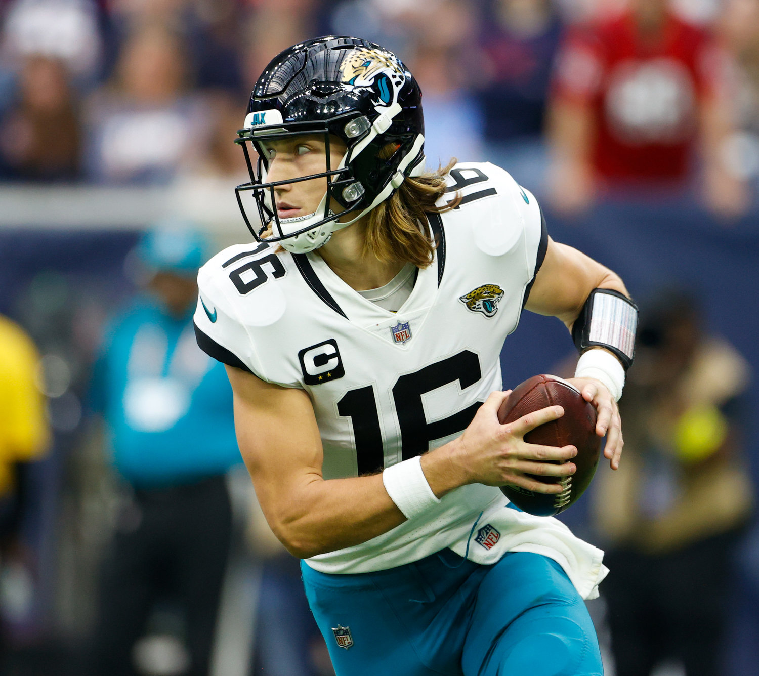 Jaguars quarterback Trevor Lawrence (16) rolls out looking to pass during an NFL game between the Houston Texans and the Jacksonville Jaguars on Jan. 1, 2023 in Houston. The Jaguars won, 31-3.