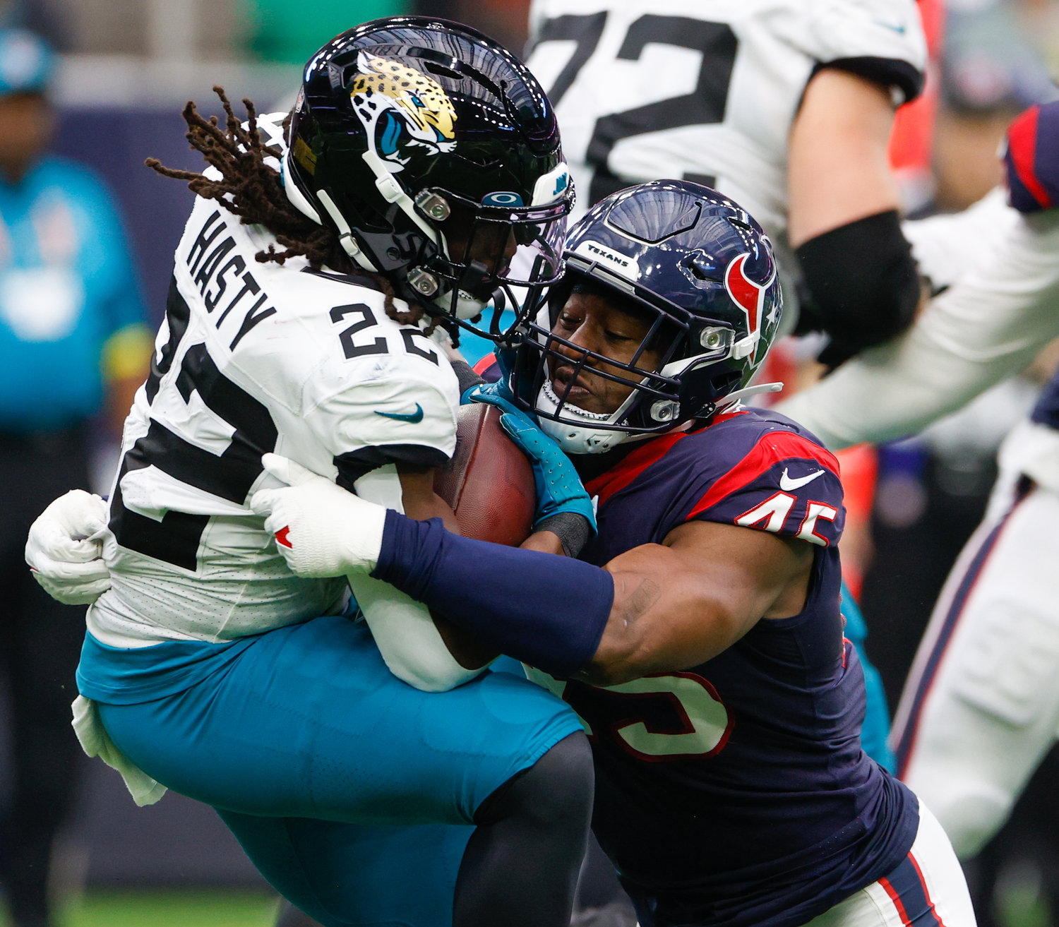 Texans linebacker Ogbonnia Okoronkwo (45) stops Jaguars running back JaMycal Hasty (22) in the backfield for a loss during an NFL game between the Houston Texans and the Jacksonville Jaguars on Jan. 1, 2023 in Houston. The Jaguars won, 31-3.