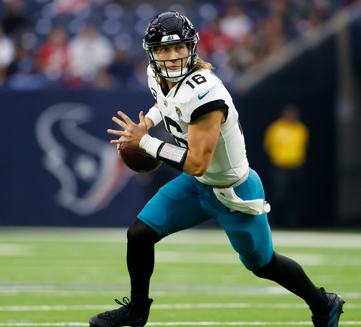Jaguars quarterback Trevor Lawrence (16) rolls out and looks downfield for a receiver during an NFL game between the Houston Texans and the Jacksonville Jaguars on Jan. 1, 2023 in Houston. The Jaguars won, 31-3.
