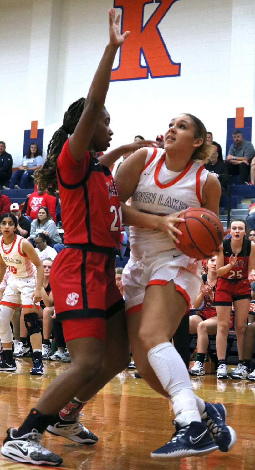Justice Carlton tries to get around Brianna Nelson during Tuesday's game between Katy and Seven Lakes at the Seven Lakes gym.
