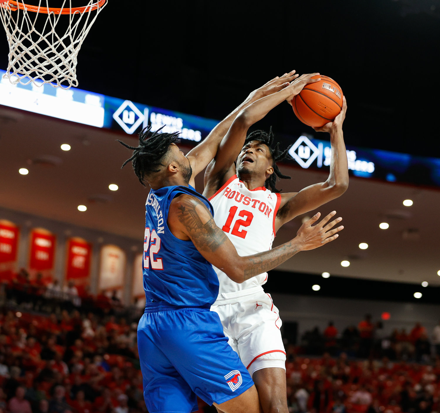 Houston guard Tramon Mark (12) goes to the basket against SMU forward Keon Ambrose-Hylton (22) during an NCAA men’s basketball game between the Houston Cougars and the Southern Methodist Mustangs on Jan. 5, 2023 in Houston. Houston won, 87-53,