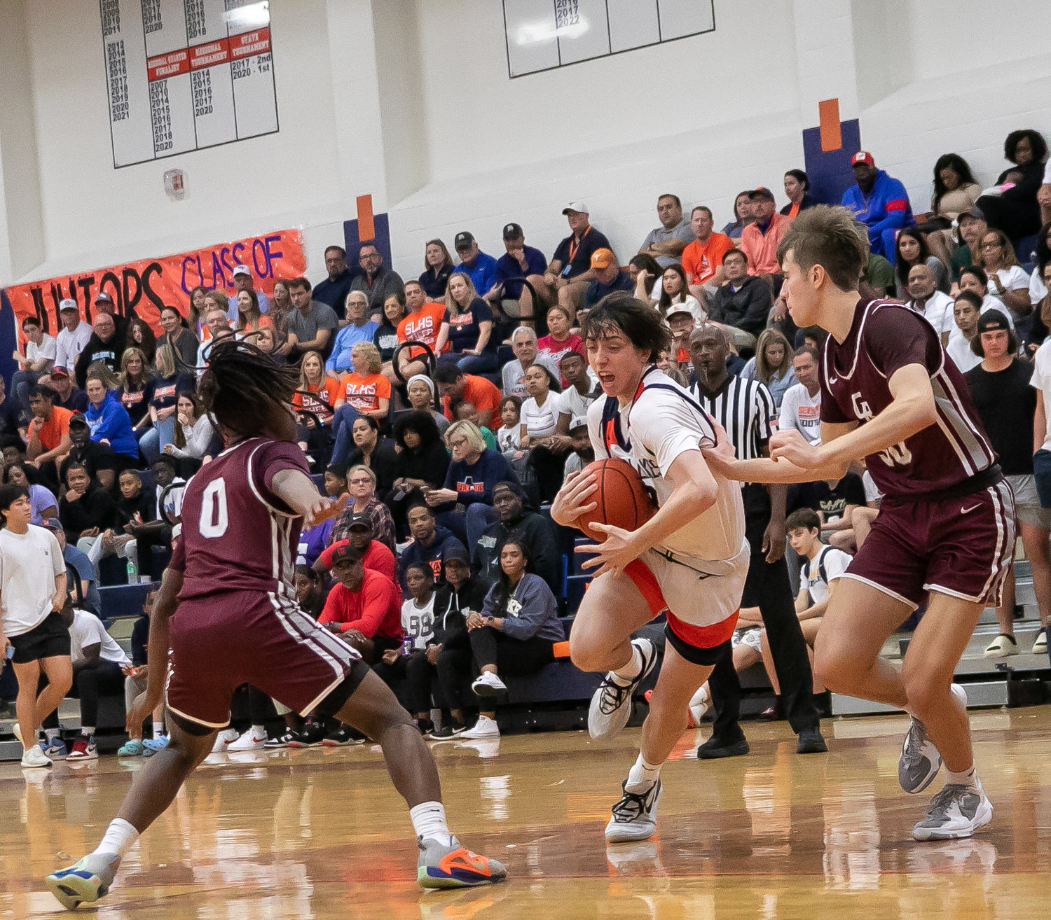 Brett Norton splits through two defenders during Saturday's game between Seven Lakes and Cinco Ranch at the Seven Lakes gym.
