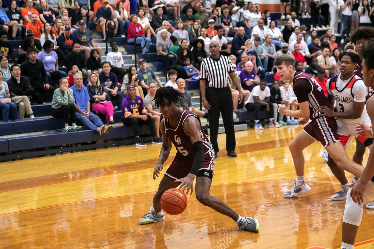 Emmanuel Gregory dribbles during Saturday's game between Seven Lakes and Cinco Ranch at the Seven Lakes gym.