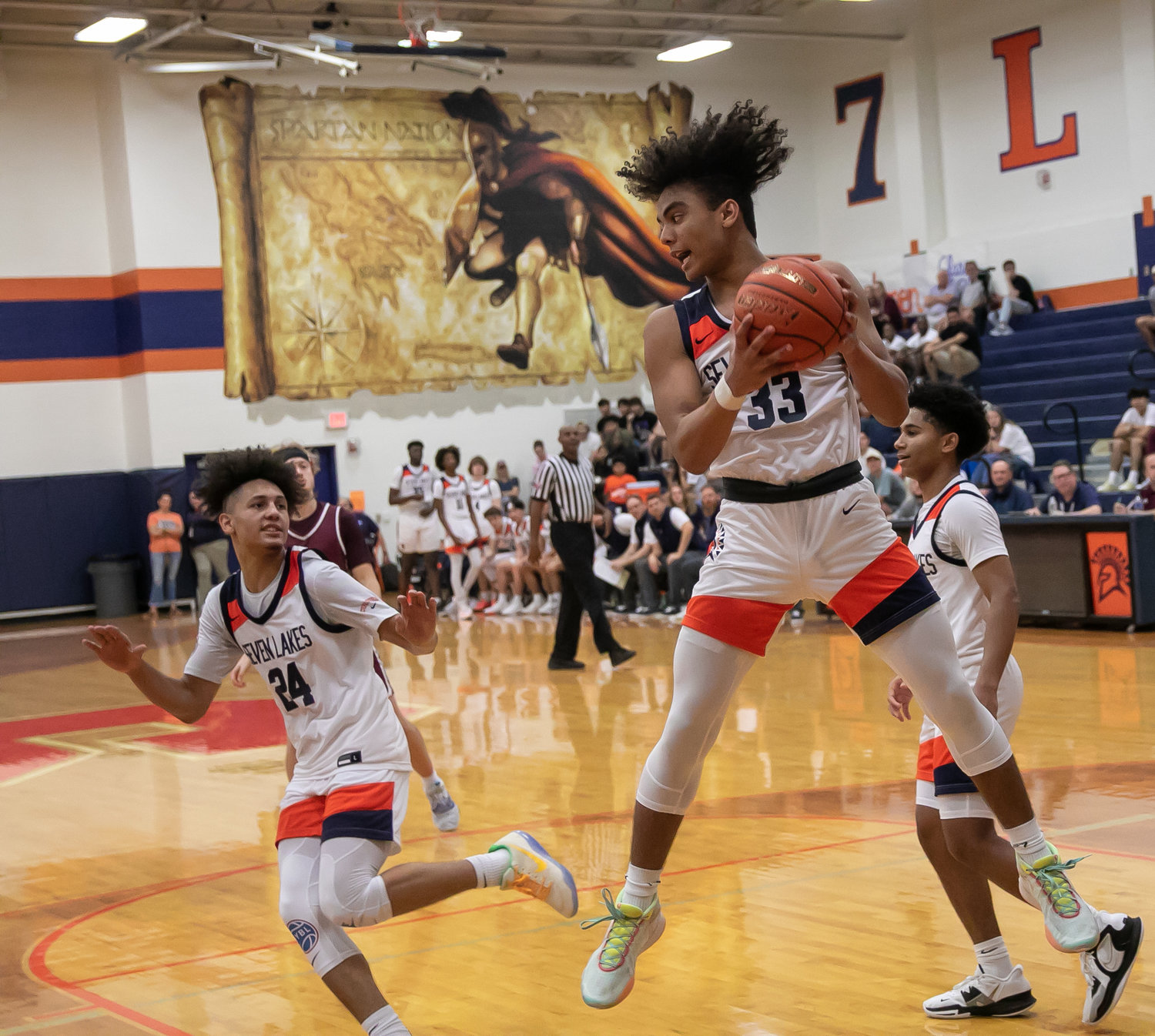 Tillman Jaramillo comes down with a rebound during Saturday's game between Seven Lakes and Cinco Ranch at the Seven Lakes gym.