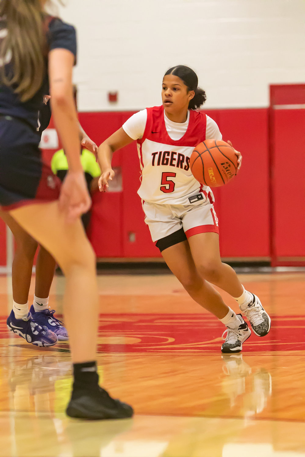 Ashlynn Alexander dribbles the ball up the court during Tuesday's game between Katy and Tompkins at the Katy gym.