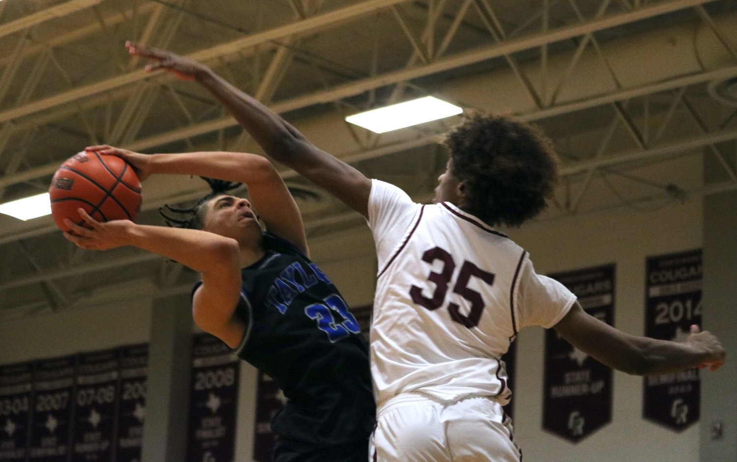 Aidean Rainey shoots over a defender during Wednesday's game between Cinco Ranch and Taylor at the Cinco Ranch gym.
