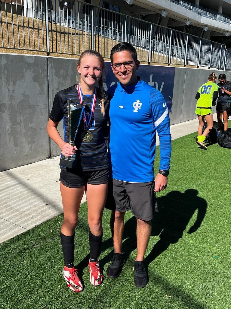 Taylor head coach Mike Agiannidis and Kendall Hemperley pose for a photo after Hempeley was named a player of the tournament at the I-10 shootout on Saturday.