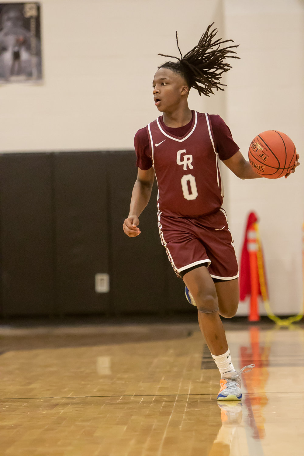 Prince Jones Bynum dribbles the ball up the court during Tuesday's game between Cinco Ranch and Jordan at the Jordan gym.