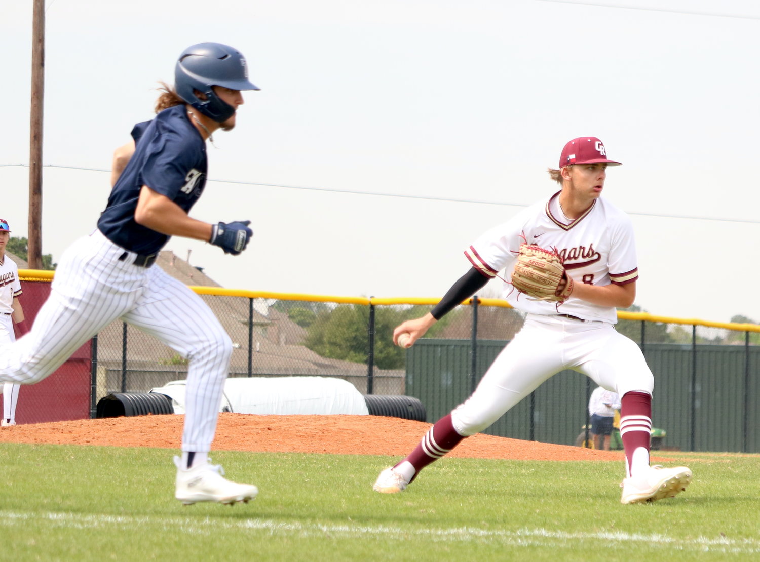 Brayden Hodge flips the ball to first base during Tuesday's game between Tompkins and Cinco Ranch at the Cinco Ranch baseball field.