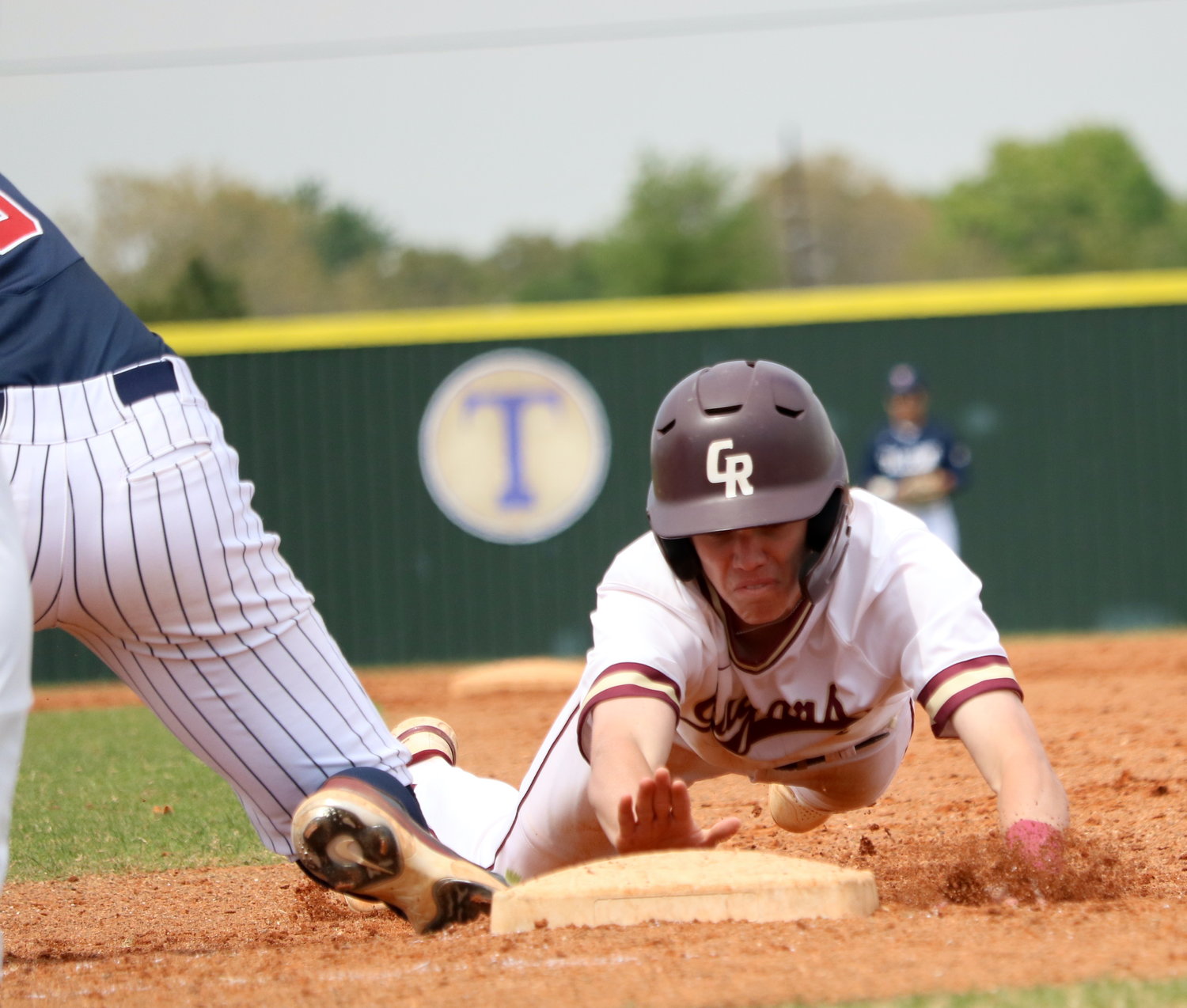 Brock DeYoung slides into first base during Tuesday's game between Tompkins and Cinco Ranch at the Cinco Ranch baseball field.