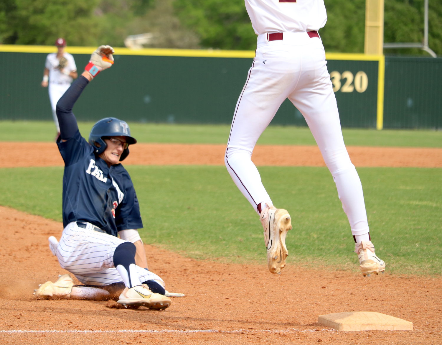 Drew Markle slides into third base after hitting a triple during Tuesday's game between Tompkins and Cinco Ranch at the Cinco Ranch baseball field.