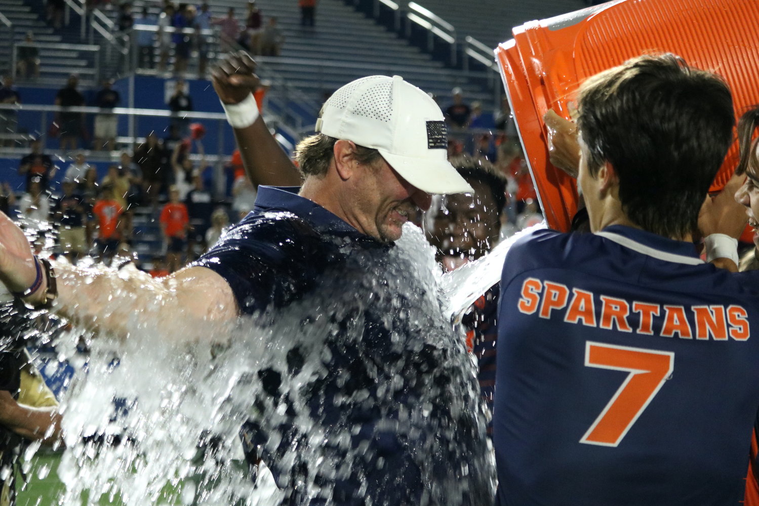 Seven Lakes head coach Jimmy Krueger gets a gatorade bath after Seven Lakes win over Dripping Springs in the Class 6A State Final at Birkelbach Field in Georgetown.