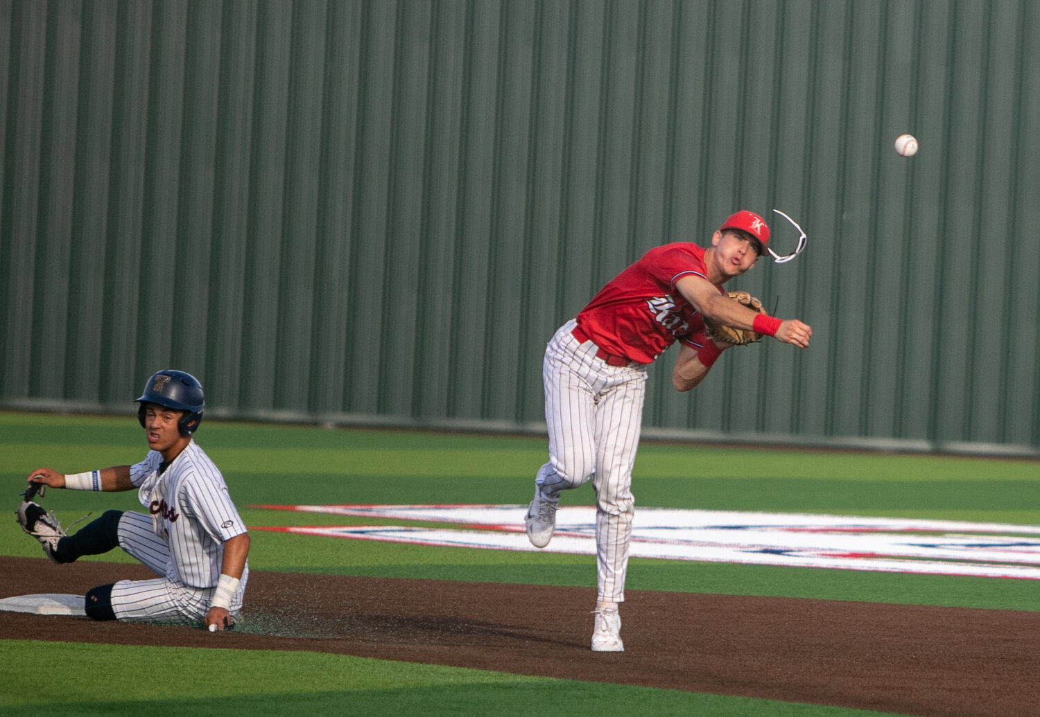 Graham Laxton turns a double play during Saturday's Regional Quarterfinal between Katy and Tompkins at Cy-Springs.