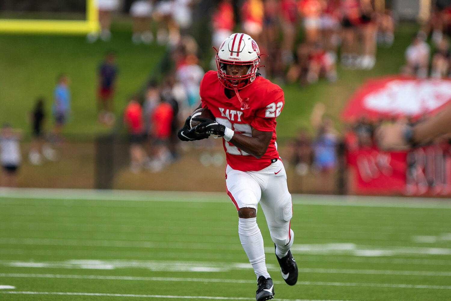 Cade McCall runs downfield during Friday's game between Katy and Tompkins at Rhodes Stadium.
