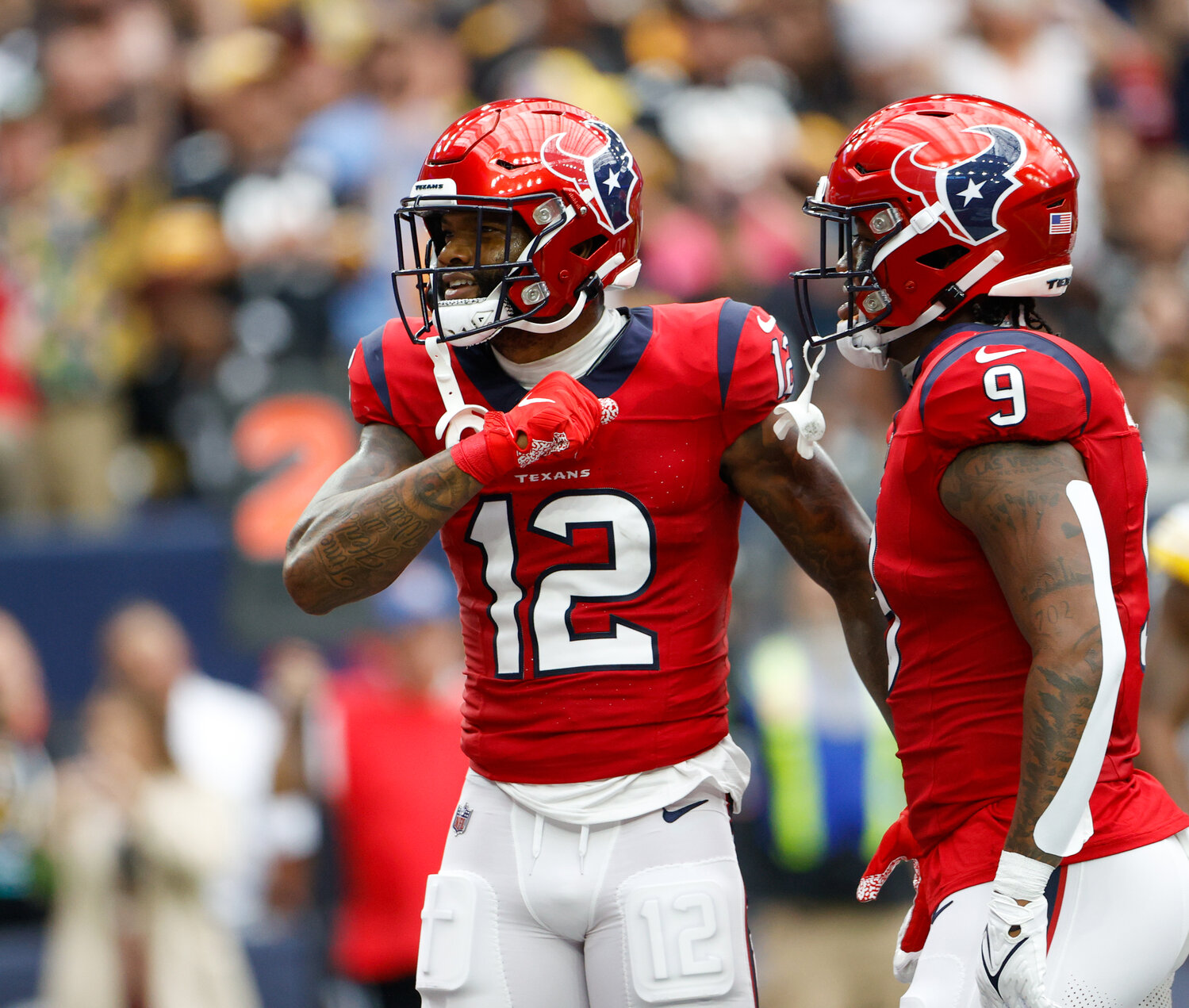 Texans wide receiver Nico Collins (12) reacts after scoring on a 2-yard touchdown catch during an NFL game between the Houston Texans and the Pittsburgh Steelers on October 1, 2023 in Houston.