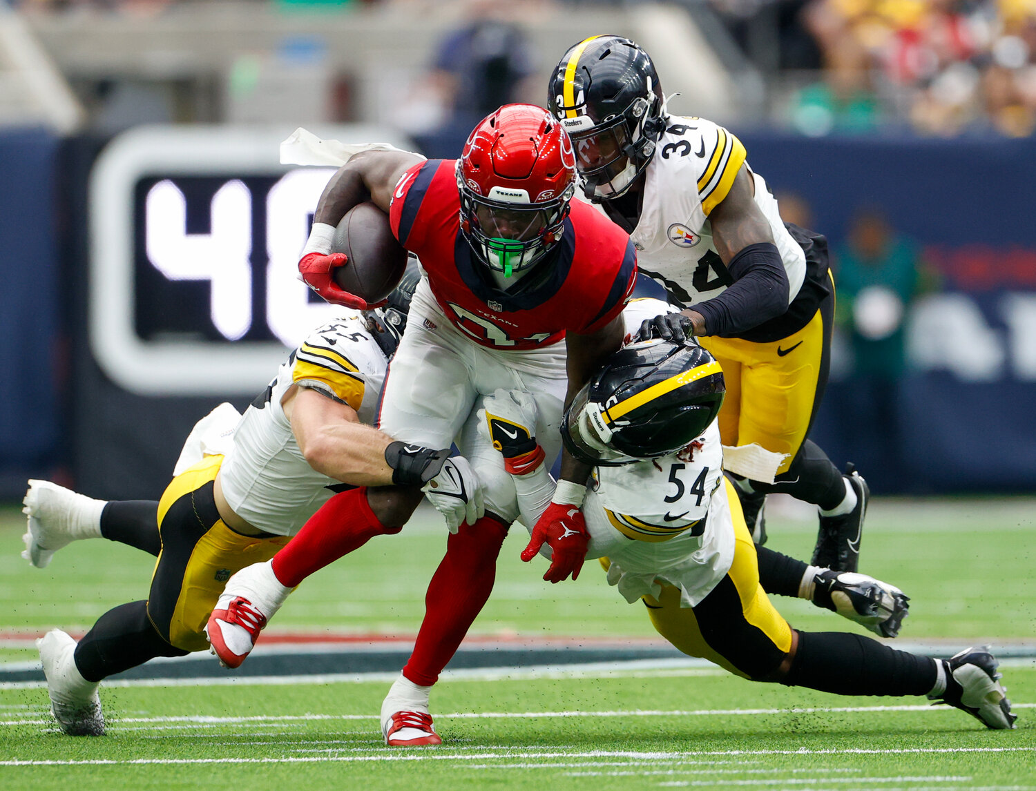 Texans running back Dameon Pierce (31) carries the ball through contact with Steelers linebackers Cole Holcomb (55) and Kwon Alexander (54 during an NFL game between the Texans and the Steelers on October 1, 2023 in Houston.