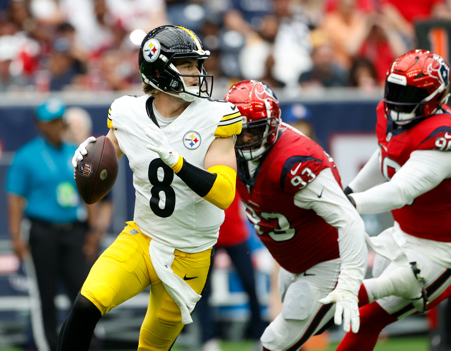 Texans defensive linemen Kurt Hinish (93) and Maliek Collins (96) pursue Steelers quarterback Kenny Pickett (8) in the backfield during an NFL game on October 1, 2023 in Houston.