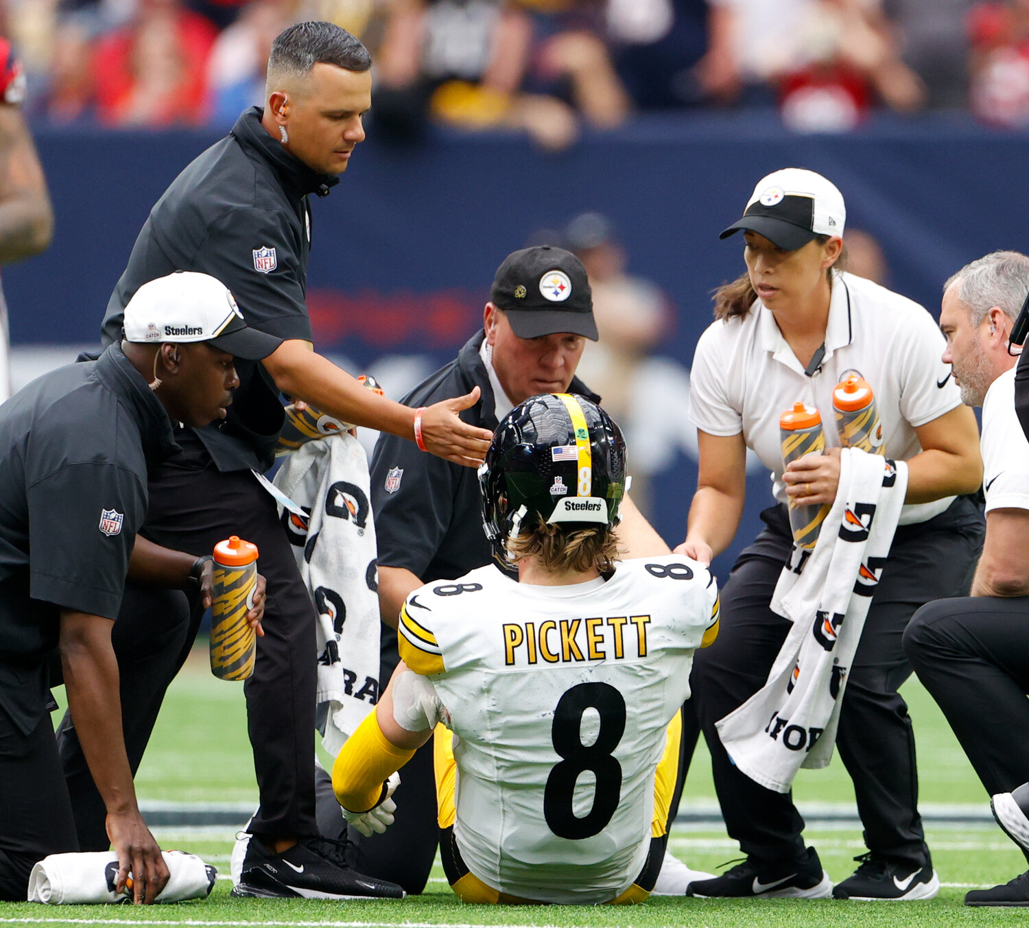 Team trainers check on Steelers quarterback Kenny Pickett (8) after a sack during an NFL game between the Houston Texans and the Pittsburgh Steelers on October 1, 2023 in Houston. Pickett left the game after suffering a reported leg injury.
