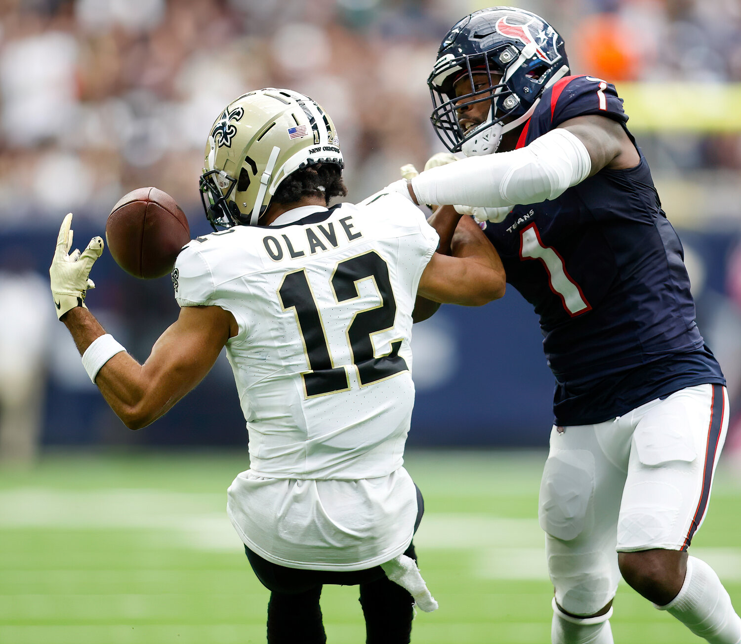 Saints wide receiver Chris Olave (12) brings in a 24-yard pass over Texans safety Jimmie Ward (1) for a first down at the Texans’ 14-yard line during an NFL game between the Texans and the Saints on October 15, 2023 in Houston. The Texans won, 20-13.