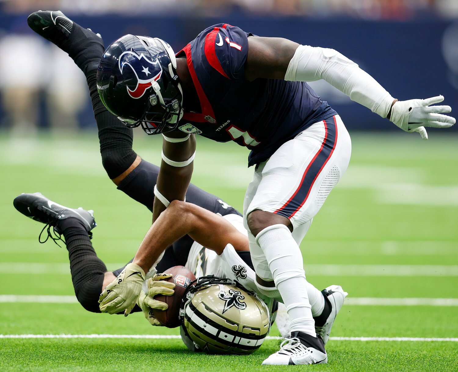 Saints wide receiver Chris Olave (12) brings in a 24-yard pass over Texans safety Jimmie Ward (1) for a first down at the Texans’ 14-yard line during an NFL game between the Texans and the Saints on October 15, 2023 in Houston. The Texans won, 20-13.