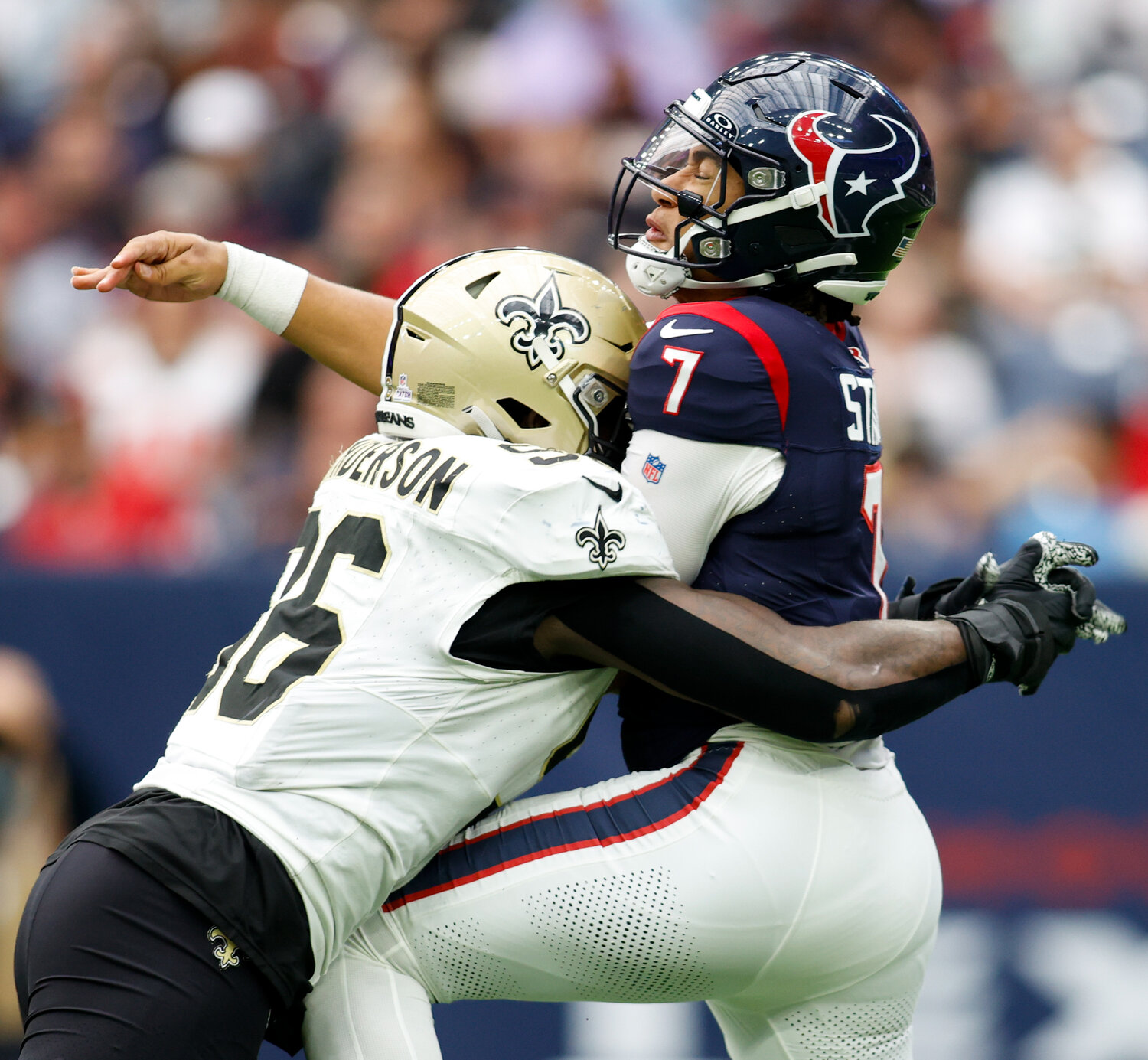 Texans quarterback C.J. Stroud (7) is hit by Saints defensive end Carl Granderson (96) after throwing a pass during an NFL game between the Texans and the Saints on October 15, 2023 in Houston. The Texans won, 20-13.