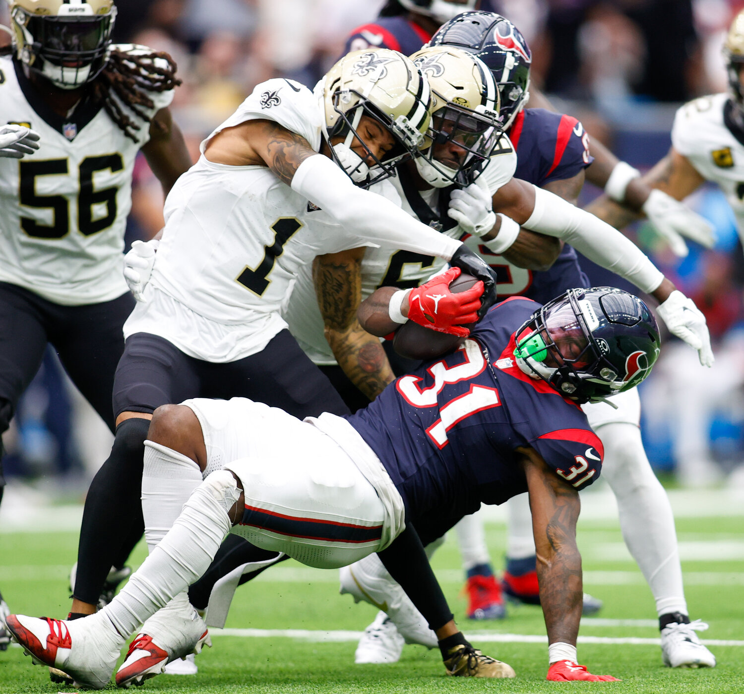 Texans running back Dameon Pierce (31) is tackled on a carry during an NFL game between the Texans and the Saints on October 15, 2023 in Houston. The Texans won, 20-13.
