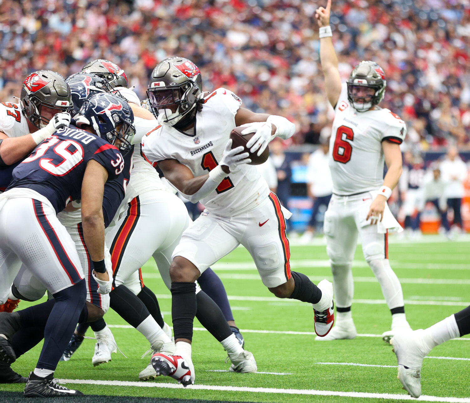 Buccaneers running back Rachaad White (1) scores on a 1-yard touchdown carry as quarterback Baker Mayfield (6) reacts in the background during an NFL game between the Houston Texans and the Tampa Bay Buccaneers on November 5, 2023 in Houston.