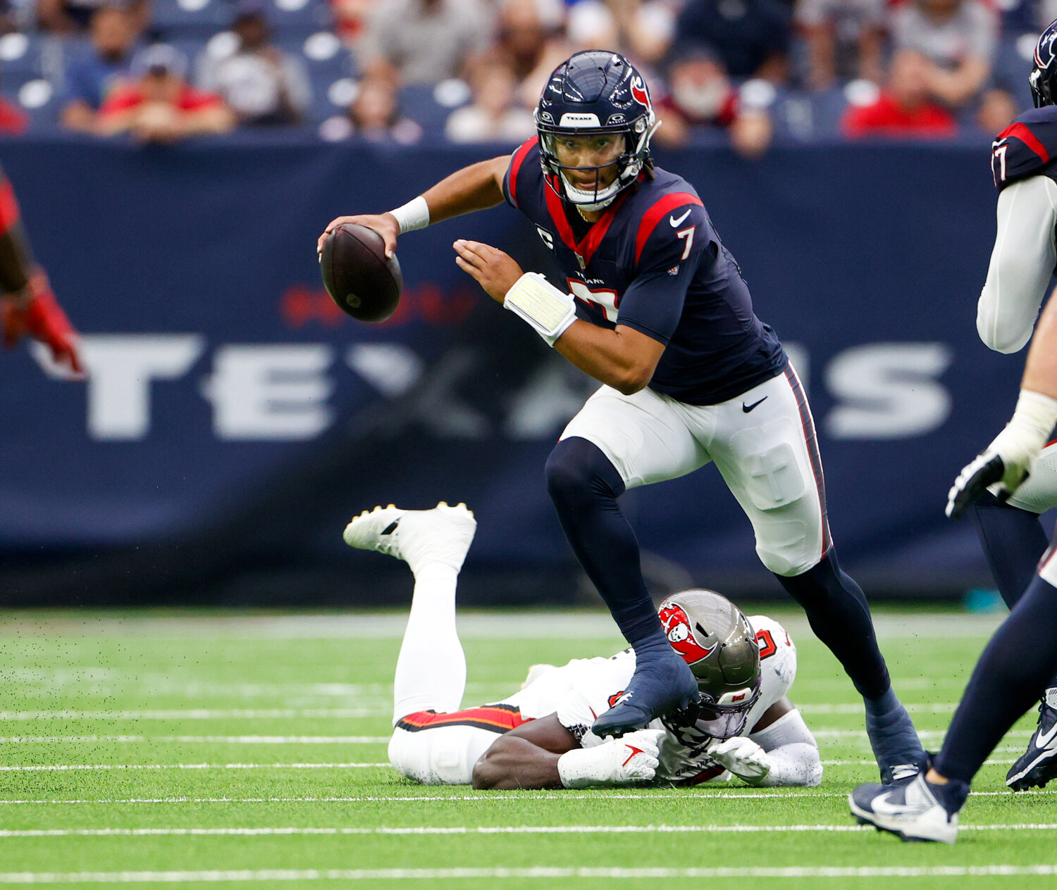 Texans quarterback C.J. Stroud (7) scrambles in the backfield while looking downfield for a receiver during an NFL game between the Houston Texans and the Tampa Bay Buccaneers on November 5, 2023 in Houston.