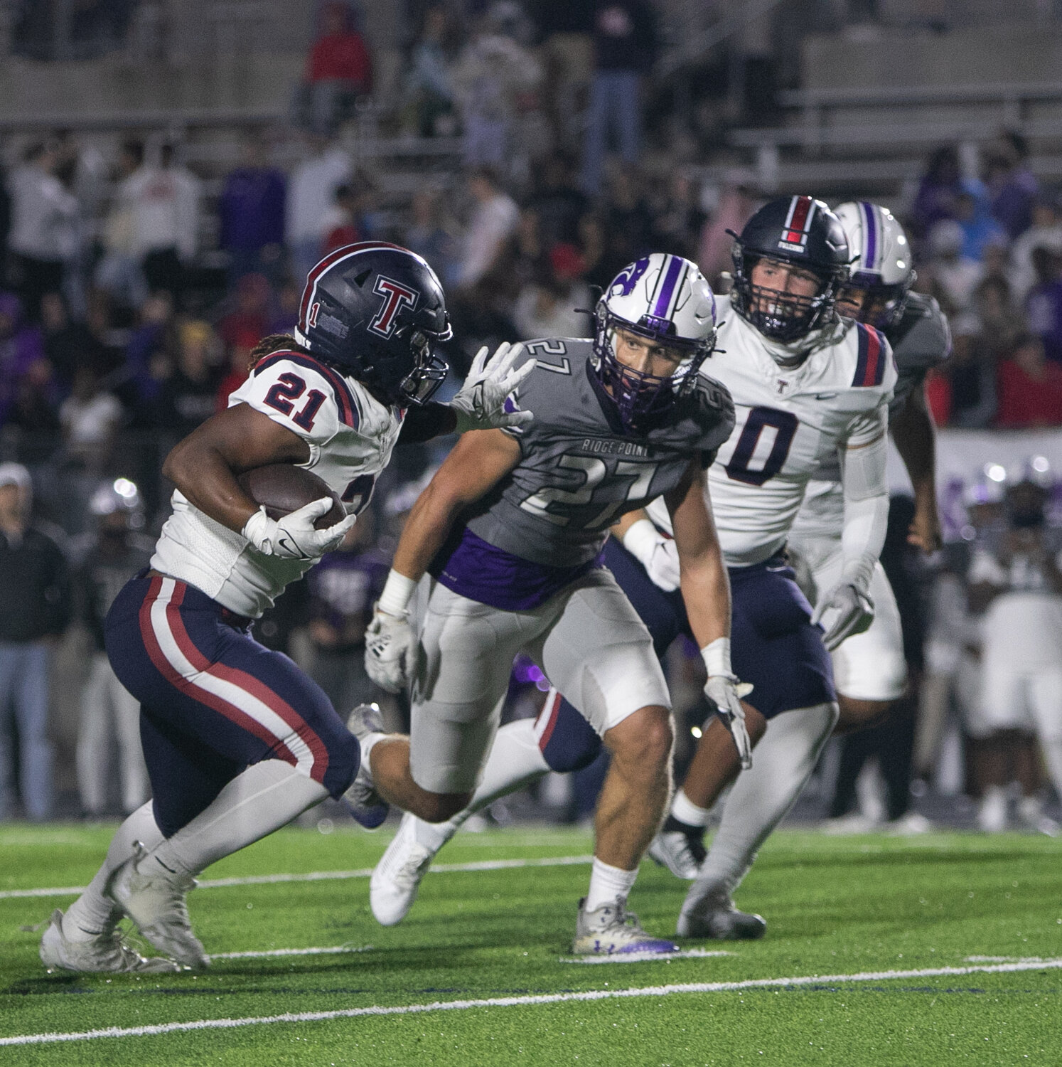 Caleb Blocker stiff arms a defender during Friday's game between Tompkins and Ridge Point at Hall Stadium.