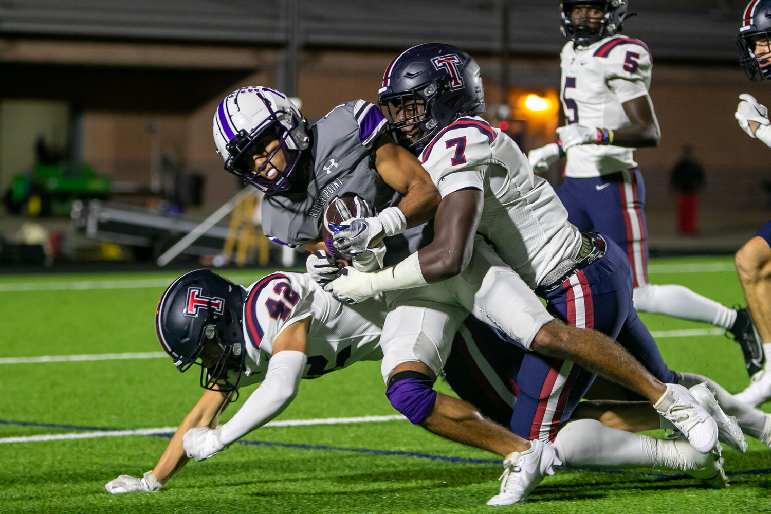 Rotimi Olayinka tackles a ball carrier during Friday's game between Tompkins and Ridge Point at Hall Stadium.
