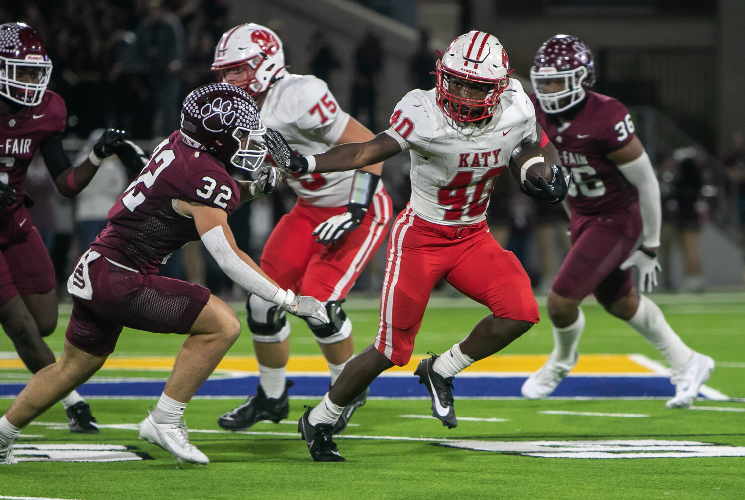 Tremayne Hill stiff-arms a defender during Friday's area round game between Katy and Cy-Fair at the Berry Center in Cypress.