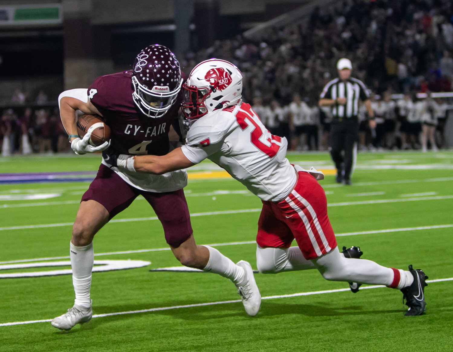 Jacob Hinton tackles a ballcarries during Friday's area round game between Katy and Cy-Fair at the Berry Center in Cypress.
