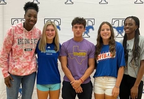 Taylor student athletes pose for a photo on national signing day.