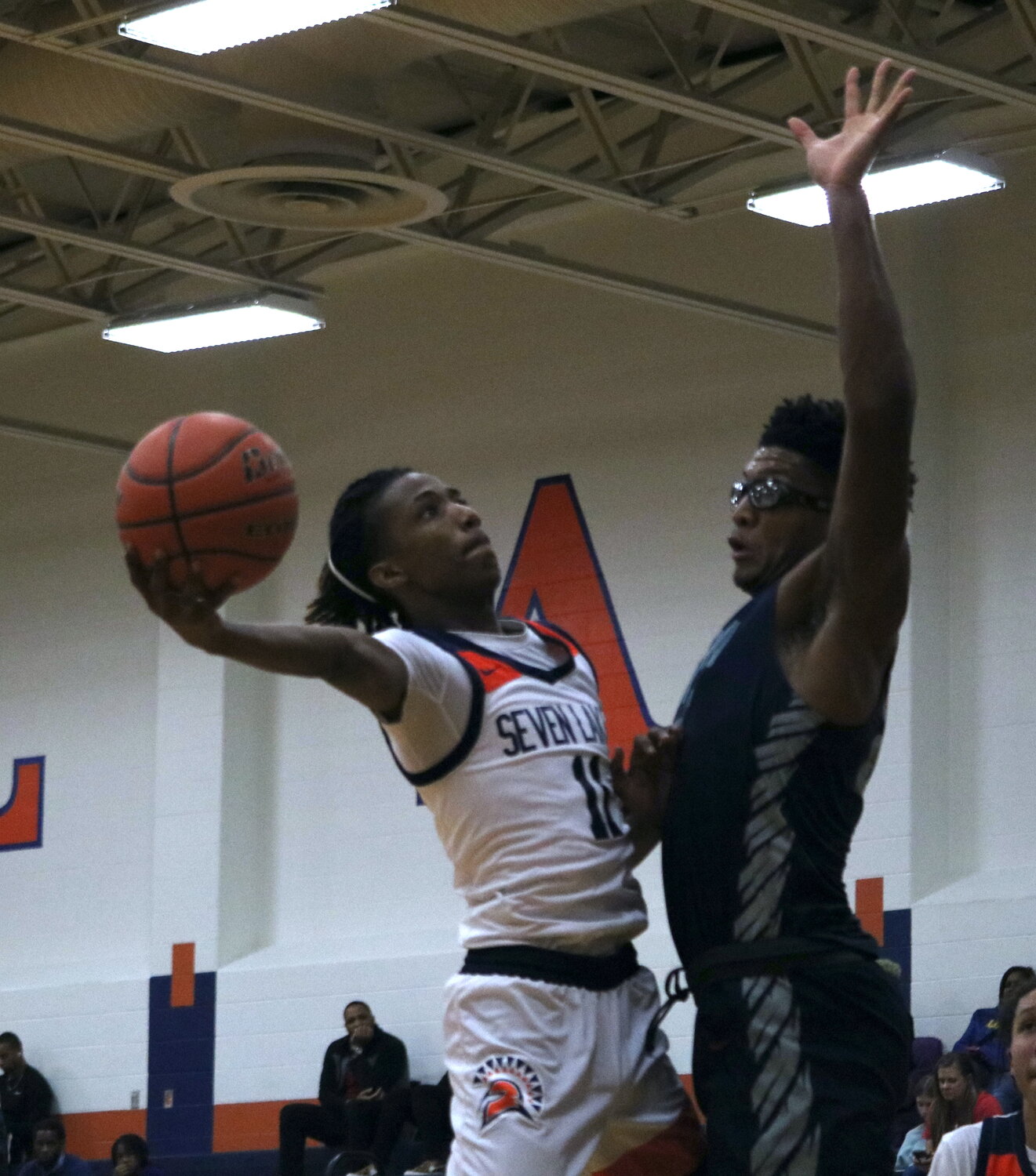 Nasir Price shoots a layup over a defender during Monday's game between Seven Lakes and Pearland Dawson at the Seven Lakes gym.