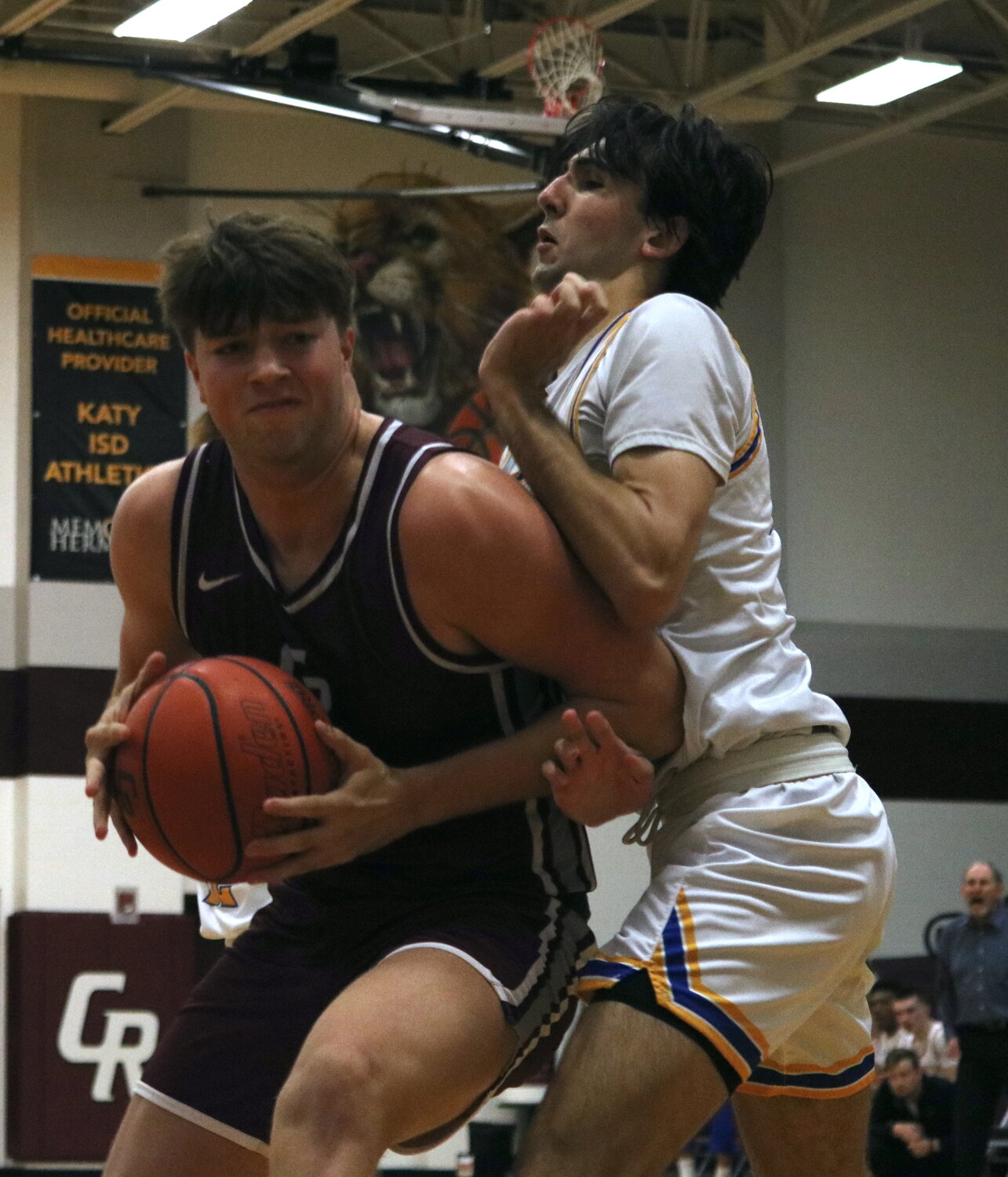Kellen LeCronier fights through a defender during Friday's game between Cinco Ranch and Klein at the Cinco Ranch gym.