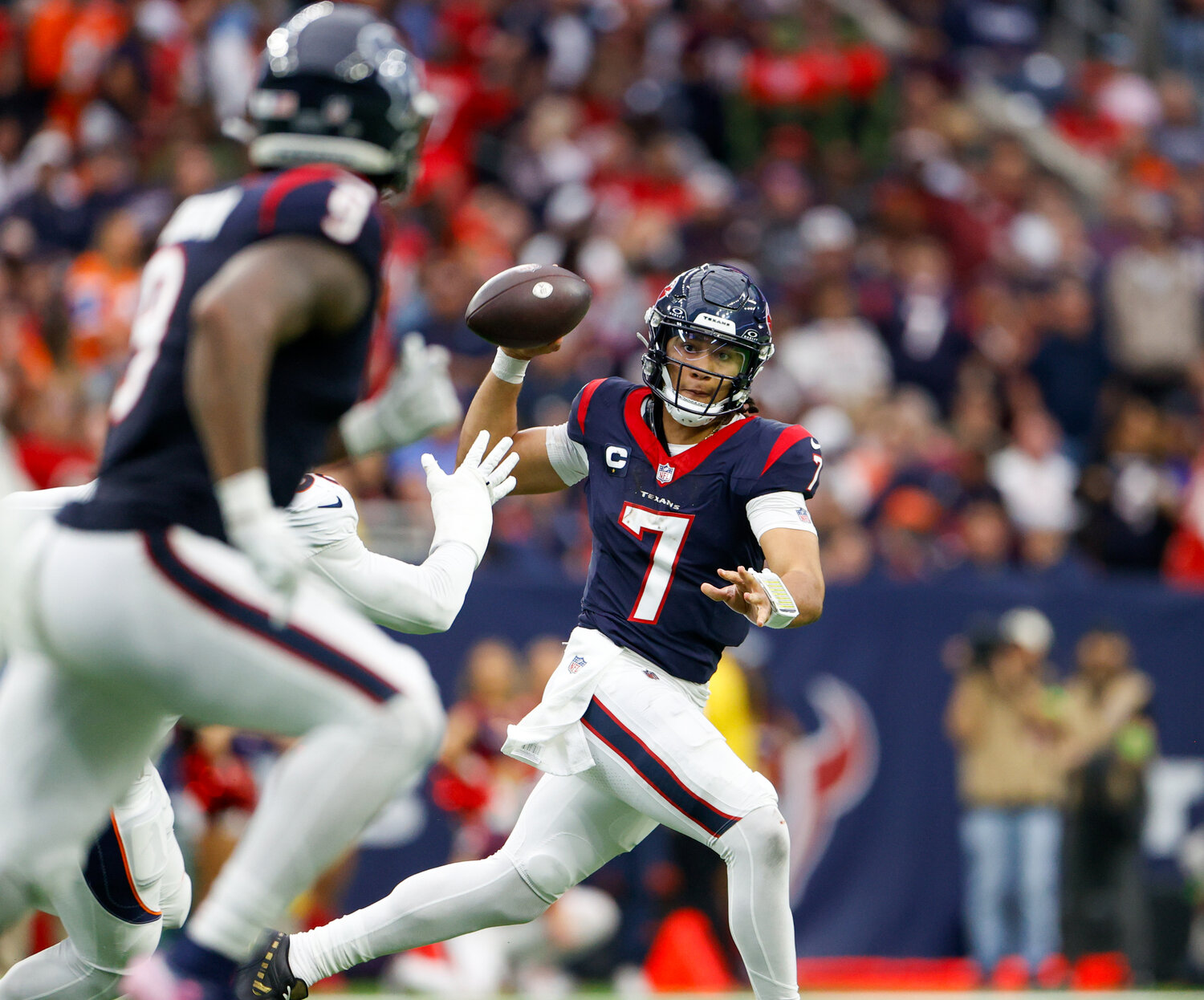 Texans quarterback C.J. Stroud (7) passes the ball to tight end Brevin Jordan (9) during an NFL game between the Texans and the Broncos on December 3, 2023 in Houston. The Texans won, 22-17.