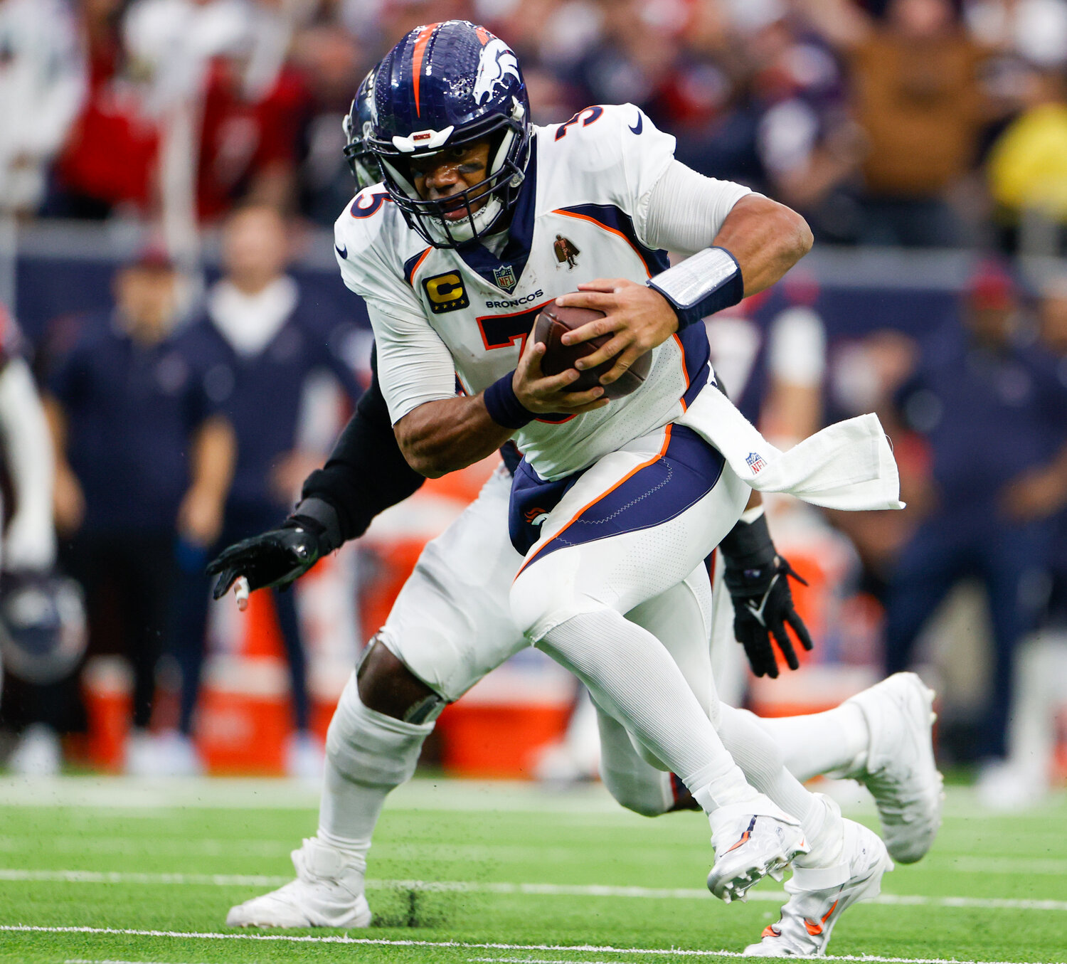 Broncos quarterback Russell Wilson (3) carries the ball for a first down during an NFL game between the Texans and the Broncos on December 3, 2023 in Houston. The Texans won, 22-17.
